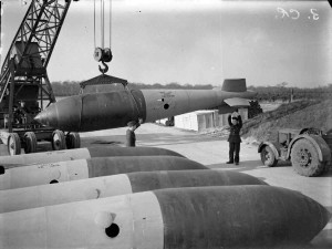 A 26 foot long 22,000-lb MC high explosive deep-penetration bomb (Bomber Command executive codeword 'Grand Slam') is manoeuvred onto a trolley by crane in the bomb dump at Woodhall Spa, Lincolnshire, for an evening raid by No. 617 Squadron RAF on the railway bridge at Nienburg, Germany. 20 aircraft took part in the raid and the target was destroyed. CH 15369 Part of AIR MINISTRY SECOND WORLD WAR OFFICIAL COLLECTION Royal Air Force official photographer Crouch F W (Flt Lt)